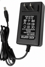 Black power adapter with plug on a white background