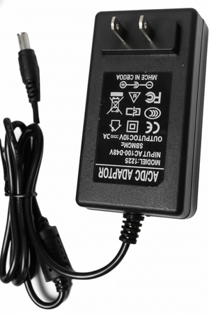 Black power adapter with plug on a white background