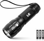 Black flashlight with 'LE' branding on a white background